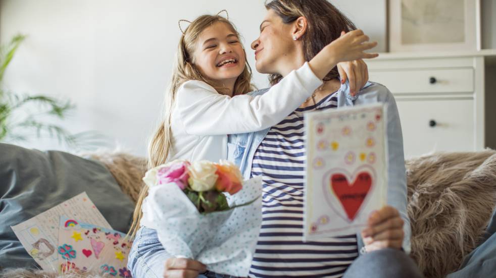 Child gifting her mum a present on Mothers Day